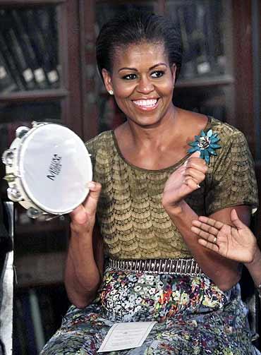 US First Lady Michelle Obama has a ball of a time as she interacts with differently-abled children at a library in the Mumbai university's south Mumbai campus