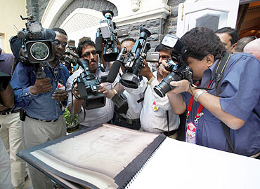 Media crowd round US President Barack Obama's handwritten note at the 26/11 memorial
