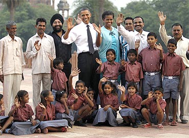 Barack and Michelle Obama with workers who restore historical buildings and their children