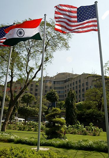 Indian and US flags fly outside the Maurya hotel