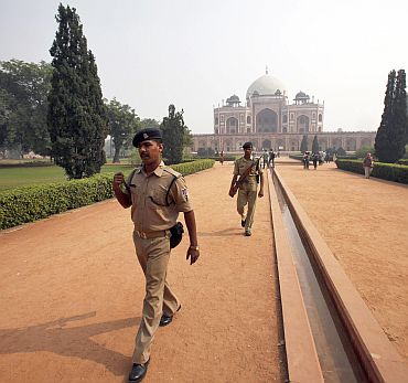 Security personnel keep watch inside the lawns of Humayun's Tomb