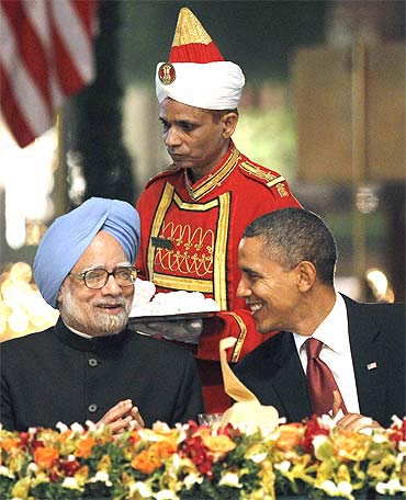 US President Barack Obama speaks with Prime Minister Manmohan Singh during their state dinner at Rashtrapati Bhavan on Monday
