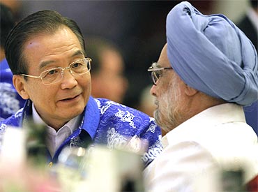 China's Premier Wen Jiabao talks with PM Dr Singh during a gala dinner with other Asian leaders at the 17th ASEAN Summit in Hanoi