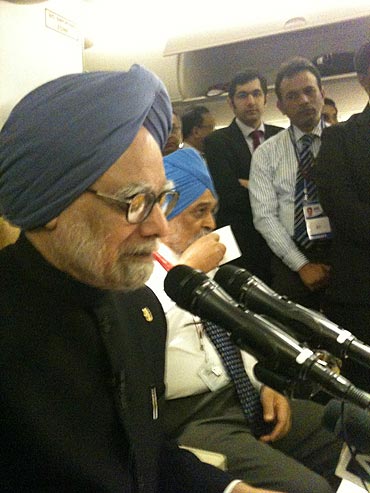 Prime Minister Manmohan Singh speaks to media-persons on board Air India One