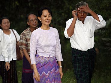 Aung San Suu Kyi walks with National League for Democracy party members after being released from house arrest in Yangon on Saturday
