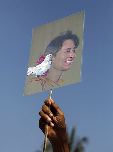 A member of the National League for Democracy holds a sketch of Aung San Suu Kyi during a protest demanding her release from house arrest in Yangon