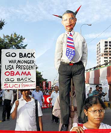 Activists with an effigy depicting President Obama during a protest in Kolkata