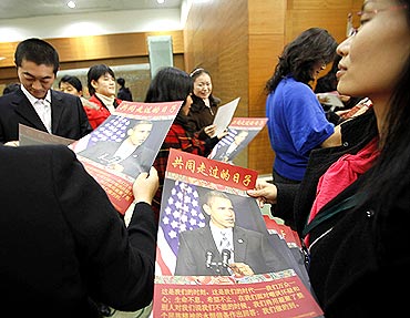 Participants with posters of President Obama after a townhall-style meeting in Shanghai, China