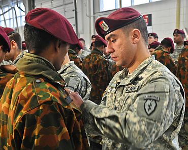 A US soldier pins US Army airborne jump wings on an Indian army soldier during a wing exchange ceremony on November 13 at Joint Base Elmendorf-Richardson, Alaska. The Soldiers earned their foreign jump wings on November 10 when they conducted a combined jump