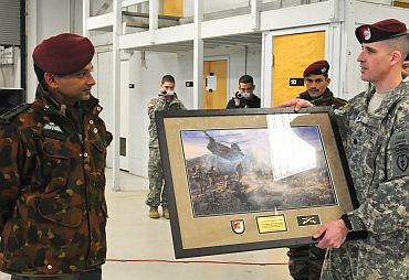 Lt Col Christopher J Cassibry, commander of 1st Squadron (Airborne), 40th Cavalry Regiment, 4th Brigade Combat Team (Airborne), 25th Infantry Division, presents a gift to a leader from the Indian army during an airborne jump wing exchange ceremony on November 13