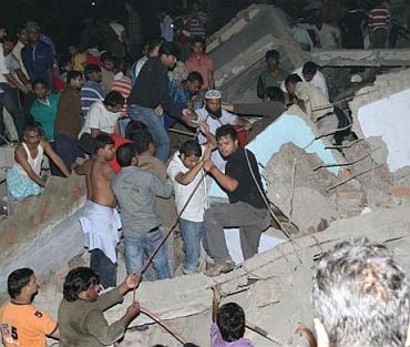 Local residents search for survivors under the rubble