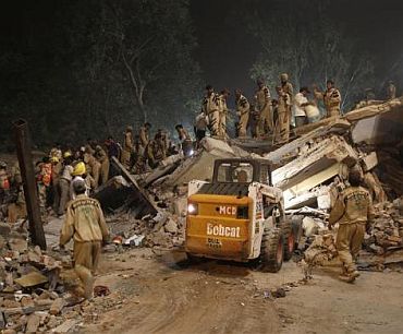 escue workers search for survivors under the rubble