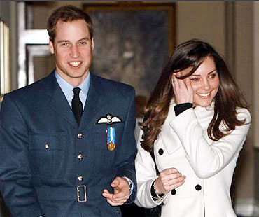 File picture of Britain's Prince William (L) is seen smiling as he walks with his girlfriend Kate Middleton at RAF Cranwell