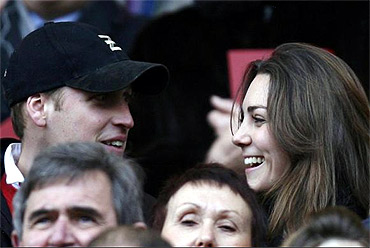 Prince Williams and his girlfriend Kate Middleton react during a rugby match in London