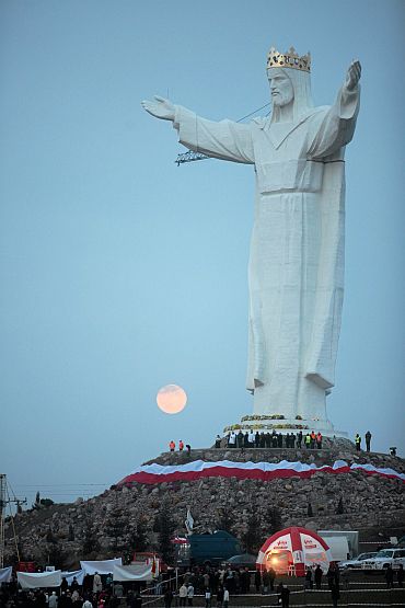 People take part in the celebrations of the unveiling of the statue of Jesus in Swiebodzin