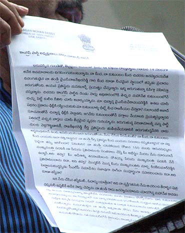 A Jagan loyalist showcases his resignation letter to Sonia Gandhi to mediapersons in Hyderabad