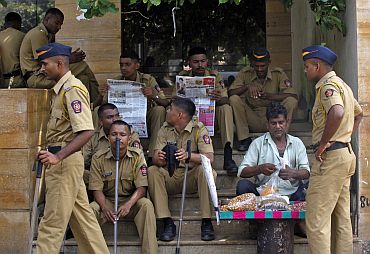 Policemen keep a watch outside a residential colony in Mumbai on Thursday