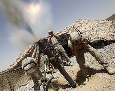 US soldiers from 1-75 Cavalry mortars, a part of 2nd Brigade, 101st Airborne, fire 120mm mortars at an enemy position in Kandahar province on September 4