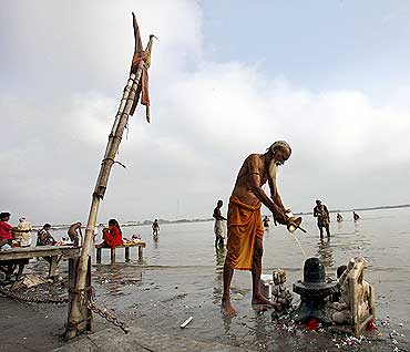 A man prays on the banks of river Saryu in Ayodhya