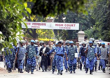 Paramilitary soldiers escort lawyers as they leave the high court in Lucknow on Sep 30, 2010