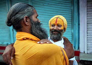 Sadhus hug each other after hearing the first reports of the Ayodhya verdict on September 30