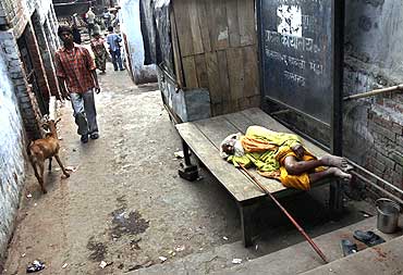 A man sleeps on a street in Ayodhya