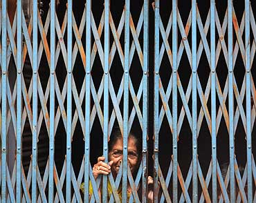 A woman looks out of her house in Ayodhya
