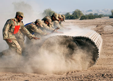 Pakistan soldiers unfold a temporary bridge during military exercises in Multan