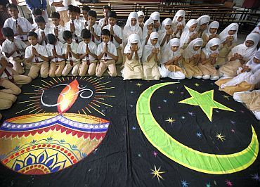 Hindu and Muslim school children offer prayers for peace inside their school in Ahmedabad