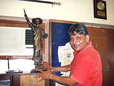 Chandrabhan Prasad at his home with a replica of the Goddess English