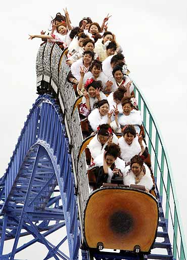 Japanese women ride a roller-coaster at Toshimaen amusement park in Tokyo