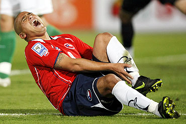Chile's Humberto Suazo reacts after a foul during a soccer match