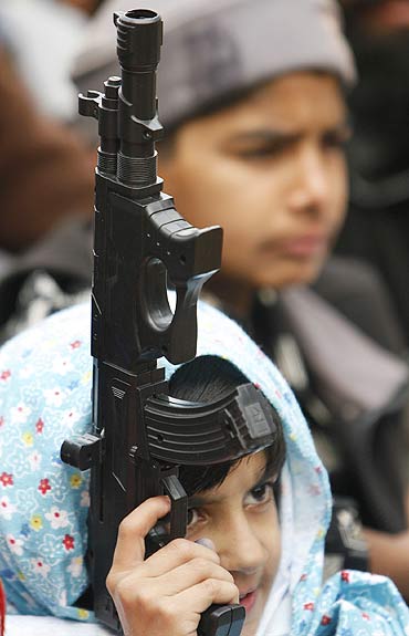 A young Jamaat-e-Islami supporter with a toy gun at a protest in Srinagar