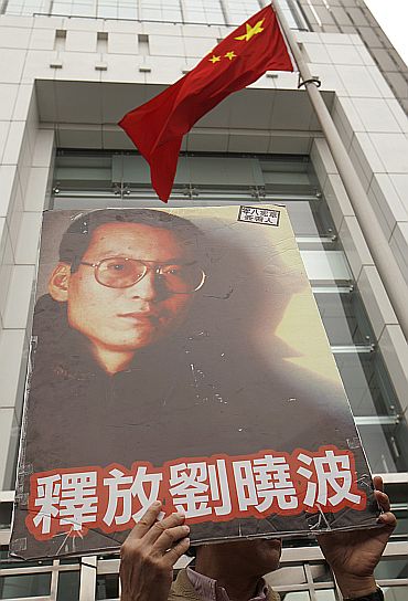 A protester holds a poster of one of China's best known dissidents Liu Xiaobo, outside the Chinese liaison office, during a protest in Hong Kong urging for Liu's release on January 25