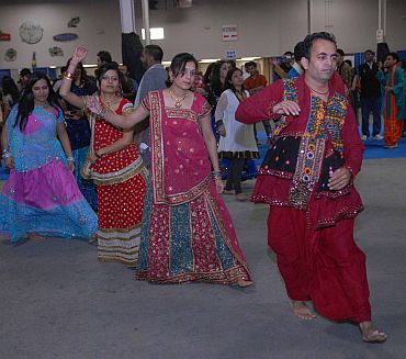 Young couples in traditional attire participate in the Navratri celebrations