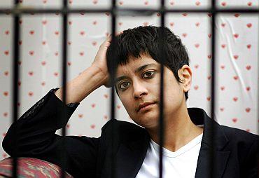 Shami Chakrabarti looks through the bars of a cage outside the Houses of Parliament as MPs debate the government's proposed anti-terror legislation in London