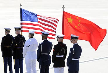 A colour guard of US and Chinese flags awaits President of China Hu Jintao's plane