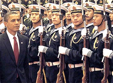 US President Barack Obama inspect honour guards during a welcome ceremony at the Great Hall of the People in Beijing
