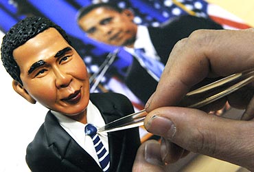 An artist crafts a figurine made from flour and water of US President Barack Obama in Shenyang, China