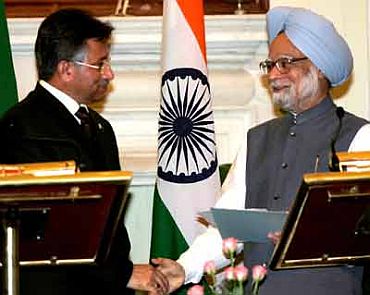 File photo shows Prime Minister Manmohan Singh shaking hands with Musharraf after making a joint statement in New Delhi on April 18, 2005