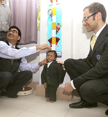 Khagendra Thapa's height is measured by Dr Hom Neupane (Left) in the presence of Guinness Book of World Records representative Marco Frigatti (Right) in Pokhara, west Nepal