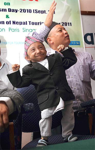 Thapa flexes his muscles during a news conference in Kathmandu