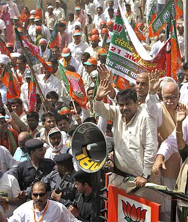 Nitin Gadkari and senior BJP leaders wave towards their supporters as they march towards the Parliament during a protest in New Delhi