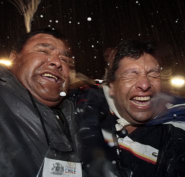 Relatives of miners celebrate after the last miner Luis Urzua was hoisted up to the surface at the San Jose mine in Copiapo on October 13