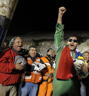 The last miner to be rescued, Luis Urzua, who is credited with organizing the miners to ration food and save themselves, gestures at the end of the rescue operation at San Jose mine in Copiapo