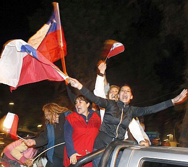Chileans celebrate after the last miner was rescued in Copiapo