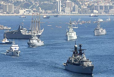 Navy ships take part with other vessels in a review