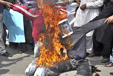 Pakistani protesters burn effigies of US President Barack Obama and former Pakistani President Pervez Musharraf, during a protest in Multan, to condemn the verdict against Aafia Siddiqui. A US judge imposed an effective life term of 86 years on Pakistani neuroscientist Siddiqui convicted of shooting at FBI agents and soldiers after her arrest in Afghanistan