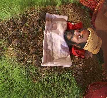 Mahant Kailash Giri, a sadhu, lies buried in soil as part of a ritual during the nine-day long Navratri festival in Jammu. The ritual was performed to appease Goddess Durga, according to Giri