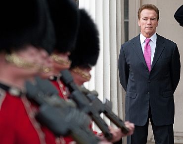 California Governor Arnold Schwarzenegger watches the changing of the guard during a visit to Wellington Barracks, in central London